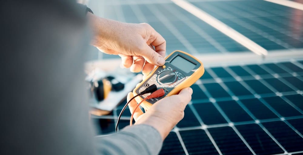 Example: Technician testing a solar panel with a multimeter