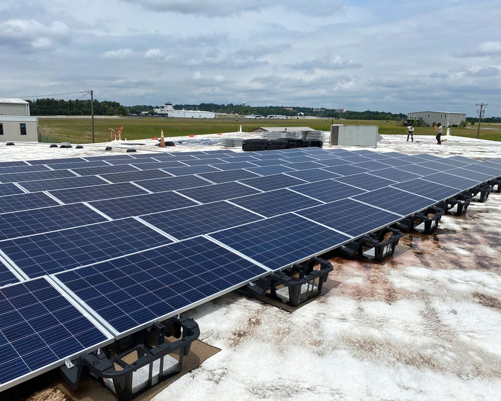 Flat-roof solar array with a crew at work