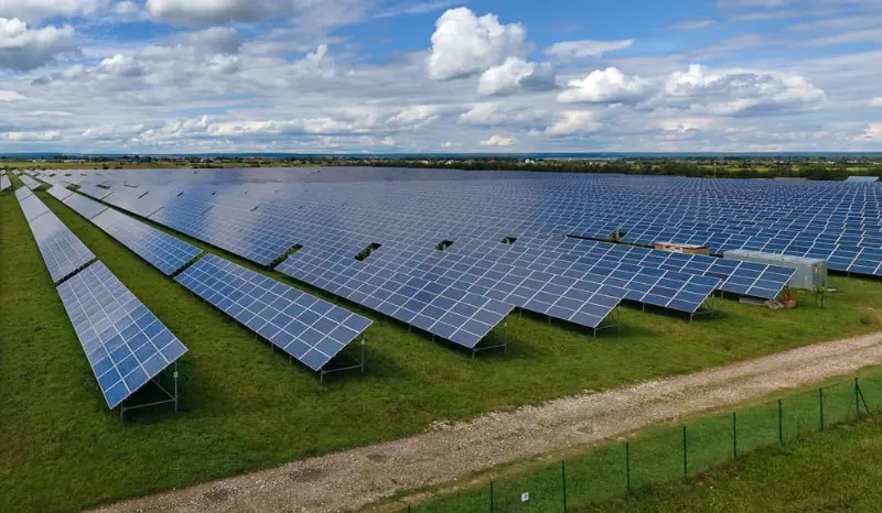 Large ground mount solar array under a cloudy sky