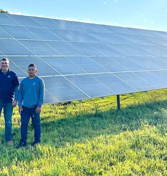 The Detail Solar crew standing in front of a ground mount solar array