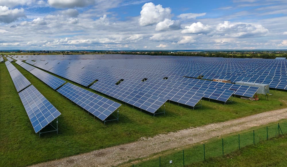 Large ground mount solar array under a cloudy sky